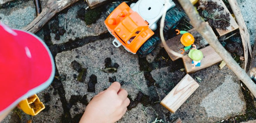 Person plays with construction toys